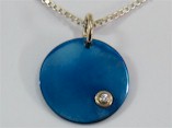 Blued Titanium and Gold  circle Pendant with a Diamond