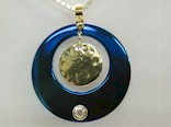 Blued Titanium Circle pendant with a centre dangle gold disk